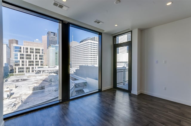 doorway featuring floor to ceiling windows and dark hardwood / wood-style flooring