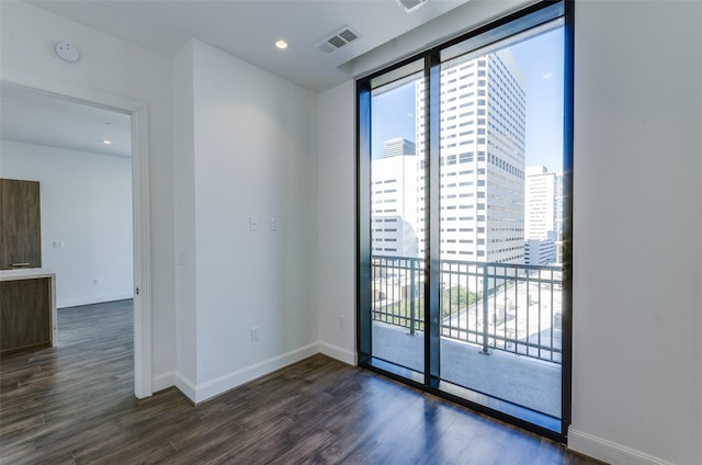 spare room featuring dark hardwood / wood-style flooring