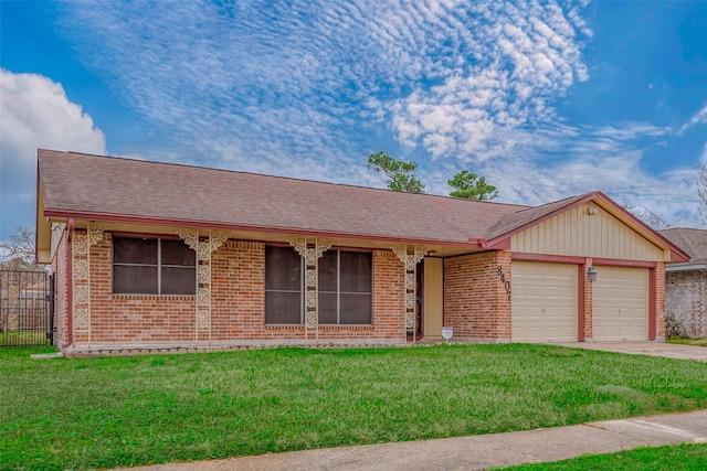 ranch-style house featuring a garage and a front yard