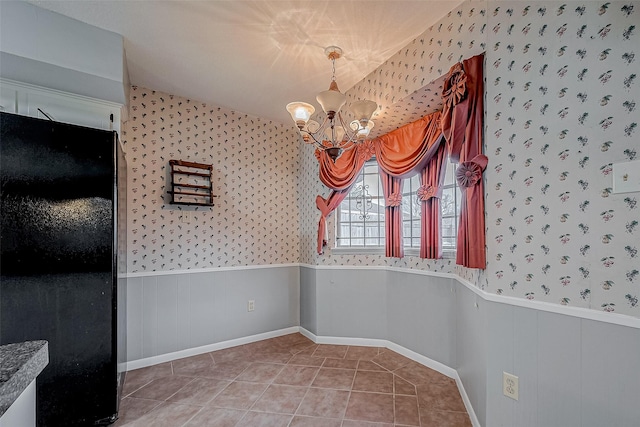 unfurnished dining area with tile patterned flooring and a chandelier