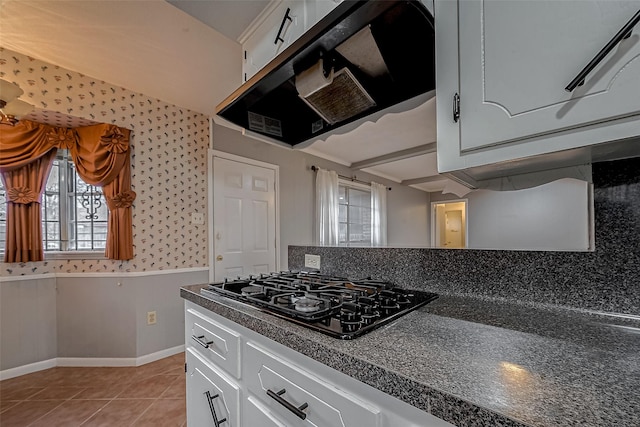 kitchen with white cabinetry, light tile patterned floors, exhaust hood, and black gas cooktop