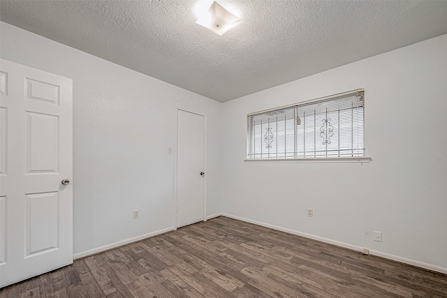 unfurnished bedroom featuring hardwood / wood-style flooring and a textured ceiling