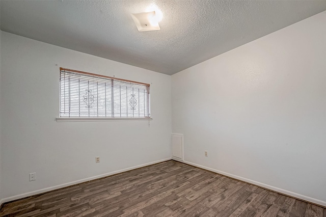 unfurnished room with hardwood / wood-style floors and a textured ceiling