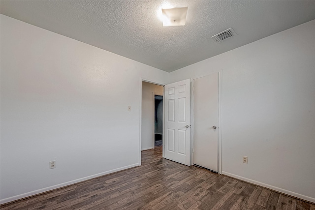 unfurnished bedroom featuring hardwood / wood-style floors and a textured ceiling