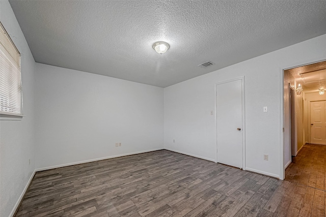 unfurnished bedroom featuring wood-type flooring and a textured ceiling