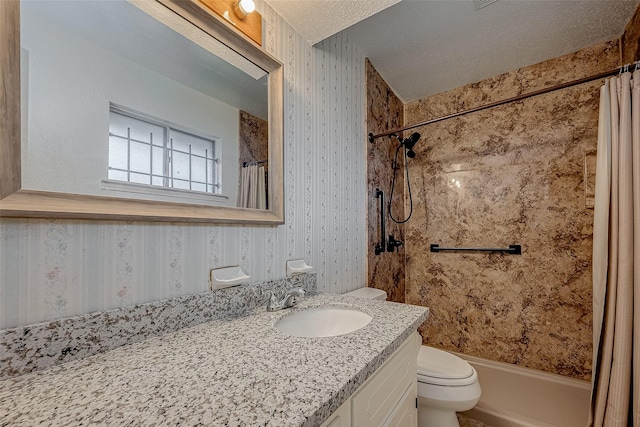 bathroom with vanity, toilet, and a textured ceiling