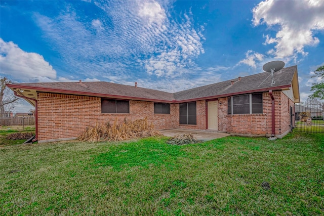 back of house with a lawn and a patio