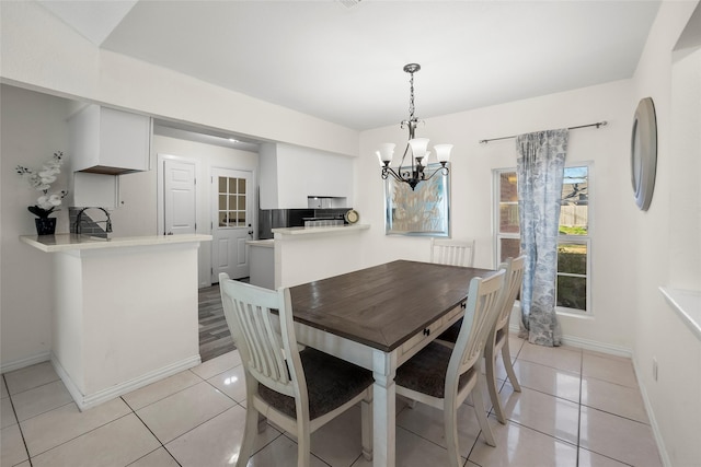 dining room featuring a notable chandelier and light tile patterned floors