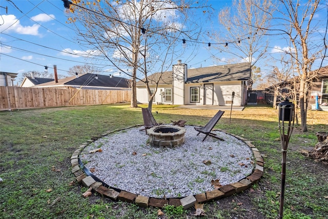 view of yard featuring an outdoor fire pit