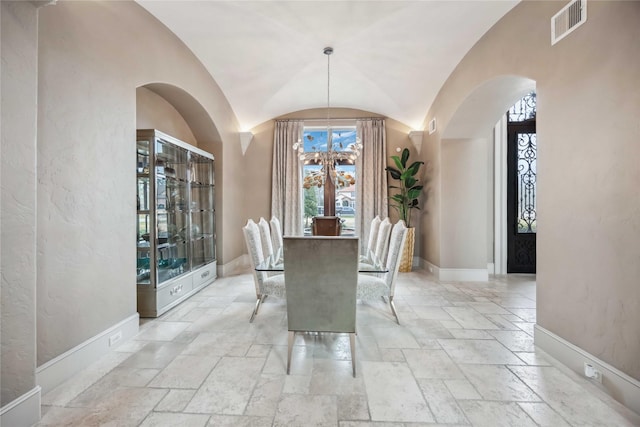 unfurnished dining area with a chandelier and vaulted ceiling