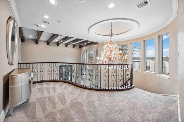 corridor with a notable chandelier, a wealth of natural light, beamed ceiling, and carpet flooring