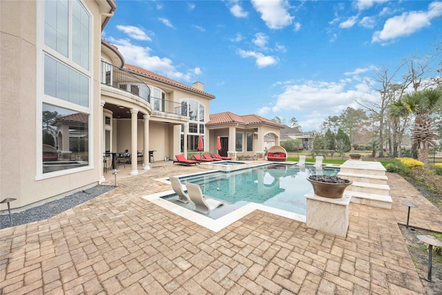 view of pool featuring a patio and an in ground hot tub