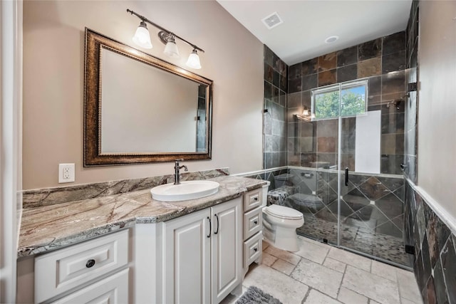 bathroom with vanity, an enclosed shower, and toilet