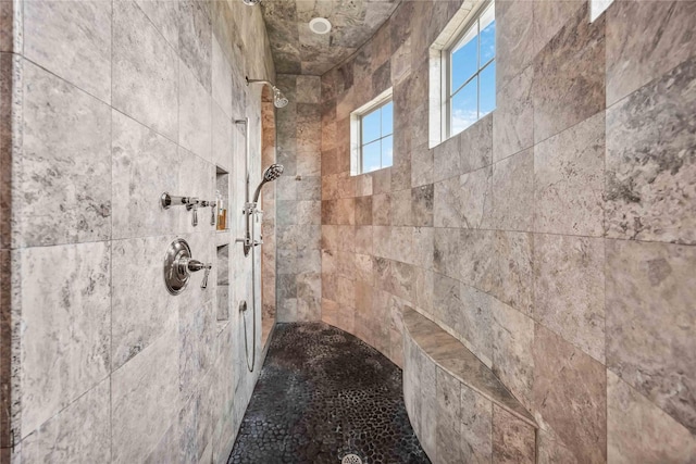 bathroom featuring a tile shower