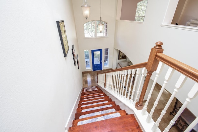 staircase with a high ceiling