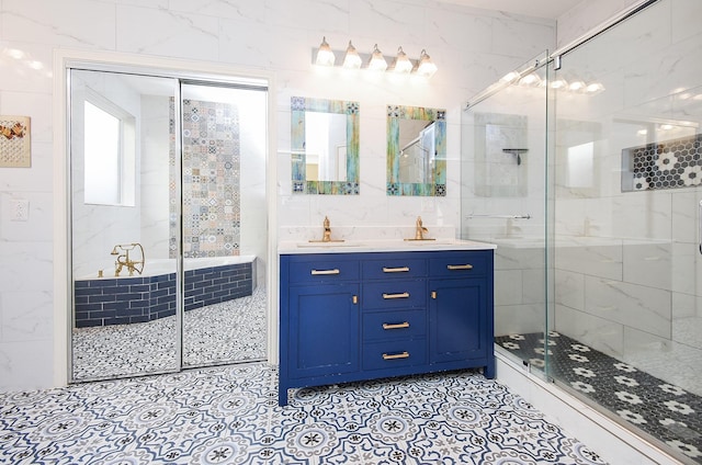 bathroom featuring vanity, a shower with shower door, and tile walls