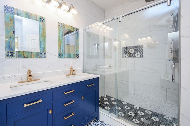 bathroom featuring vanity, tasteful backsplash, a shower with door, and tile walls