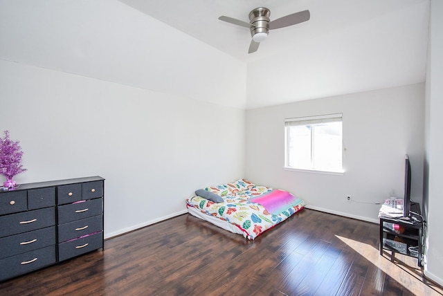 bedroom with ceiling fan, lofted ceiling, and dark hardwood / wood-style floors