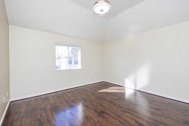 unfurnished room featuring lofted ceiling and hardwood / wood-style floors