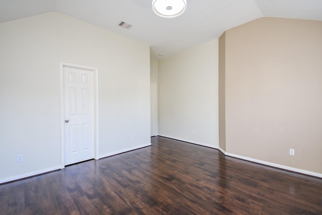 empty room with lofted ceiling and dark hardwood / wood-style floors