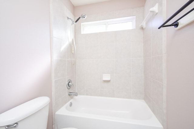 bathroom with toilet and tiled shower / bath combo