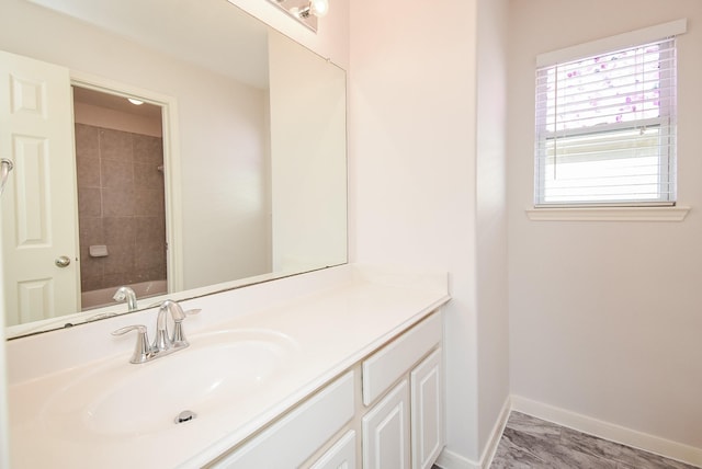 bathroom with vanity and a washtub