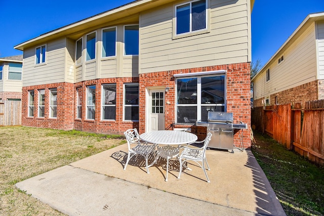 back of house featuring a patio area and a lawn