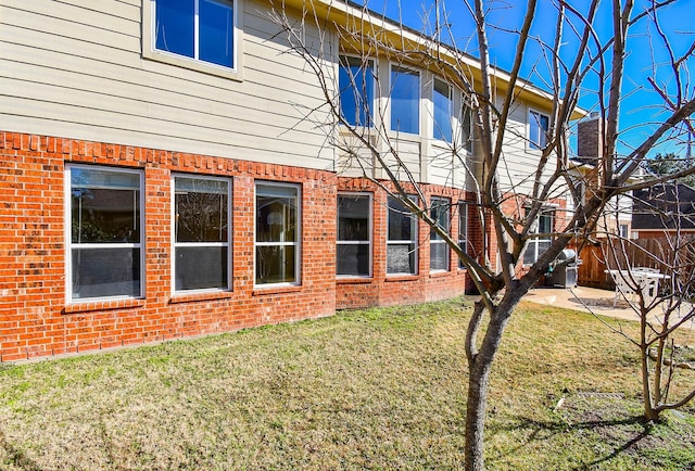 rear view of property with a lawn