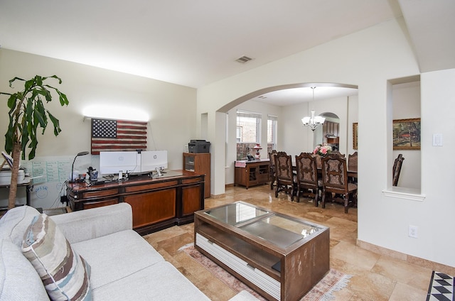 living room featuring lofted ceiling and a notable chandelier