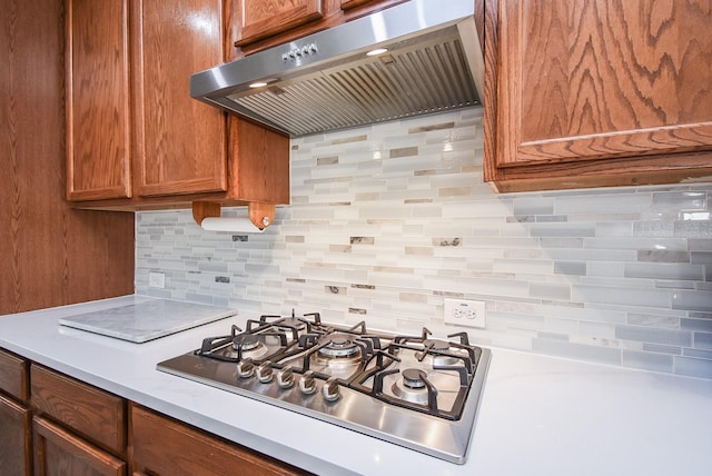 kitchen with gas stovetop, tasteful backsplash, and exhaust hood