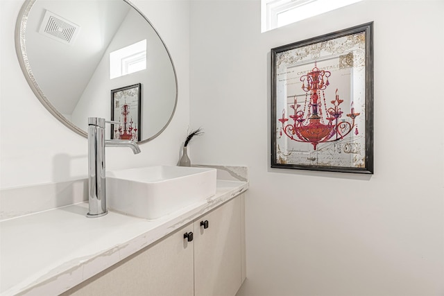 bathroom featuring vanity and vaulted ceiling