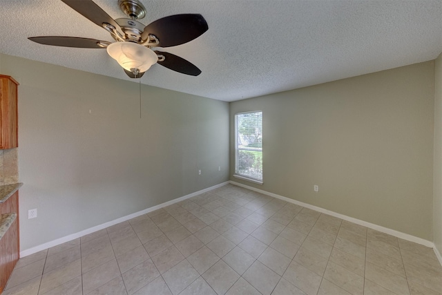 unfurnished room featuring ceiling fan, a textured ceiling, and light tile patterned floors