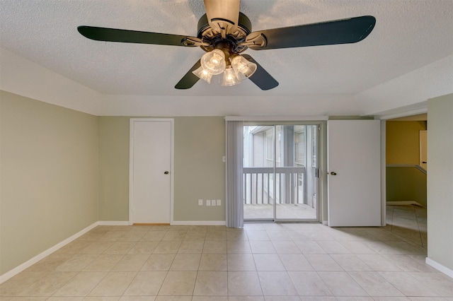 unfurnished room featuring light tile patterned flooring, ceiling fan, and a textured ceiling