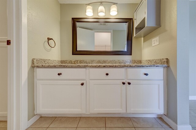 bathroom featuring tile patterned floors and vanity