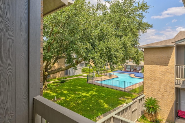 view of swimming pool featuring a yard and a patio