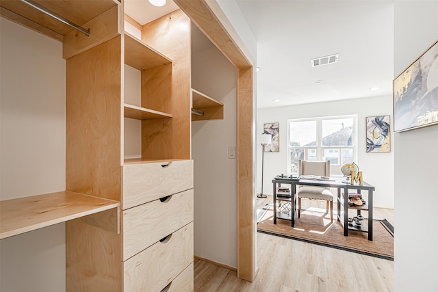 spacious closet with light wood-style flooring and visible vents