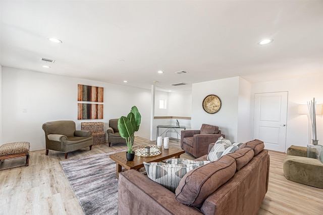 living area featuring light wood-type flooring, visible vents, and recessed lighting