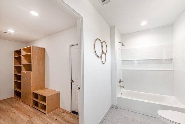 bathroom featuring toilet, bathtub / shower combination, visible vents, and recessed lighting