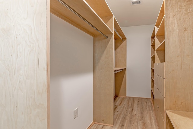 walk in closet with light wood-style flooring and visible vents