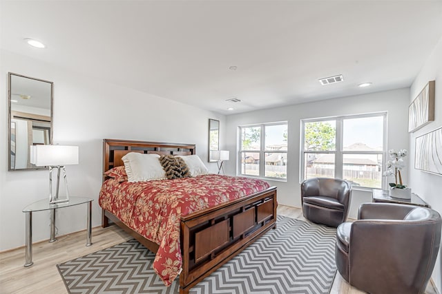 bedroom featuring light wood-type flooring, visible vents, and recessed lighting