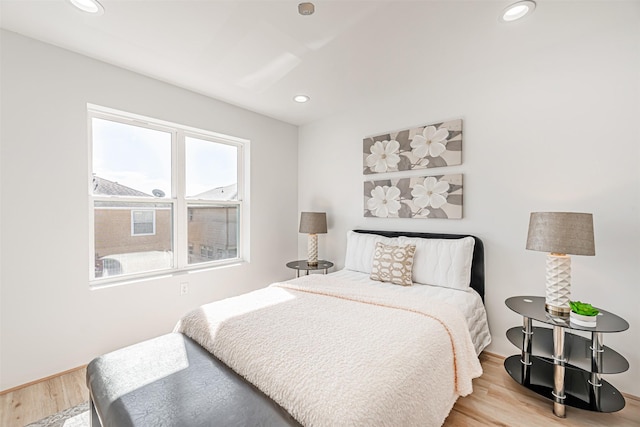 bedroom with wood finished floors and recessed lighting