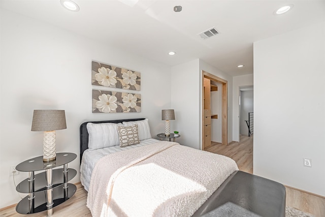 bedroom featuring light wood-type flooring, visible vents, and recessed lighting