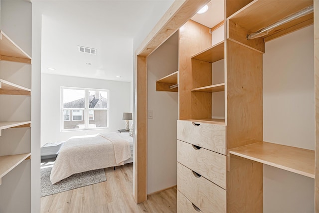 spacious closet with light wood-style flooring and visible vents