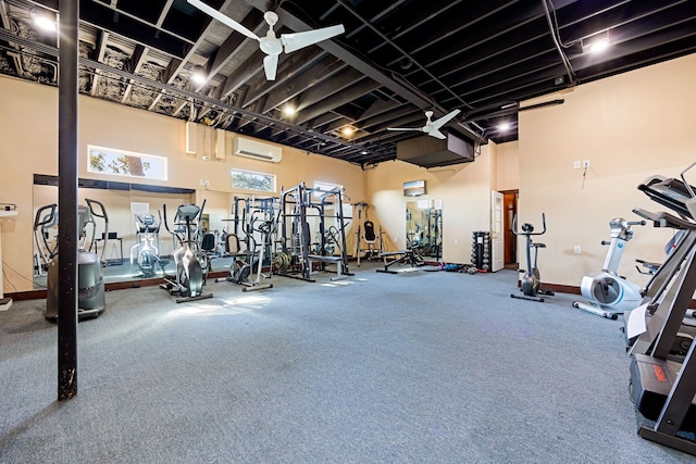 workout area with a high ceiling and a wall mounted air conditioner