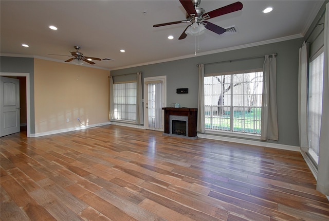 unfurnished living room with crown molding, wood-type flooring, and ceiling fan