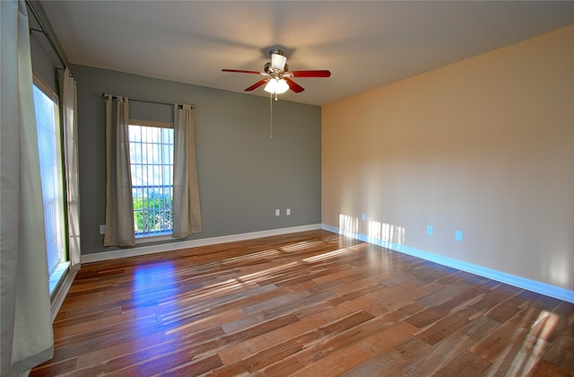 empty room featuring dark hardwood / wood-style flooring and ceiling fan