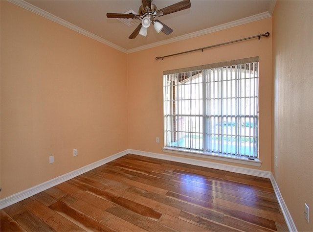 empty room with hardwood / wood-style flooring, ornamental molding, and ceiling fan