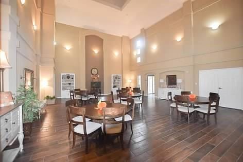 dining room featuring a towering ceiling and dark hardwood / wood-style floors