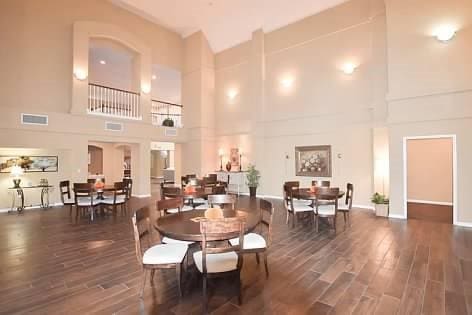 dining area with dark hardwood / wood-style floors and a high ceiling