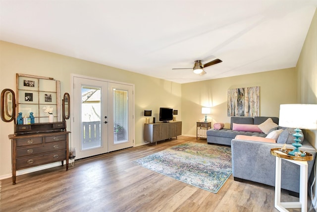 living room featuring hardwood / wood-style flooring, ceiling fan, and french doors